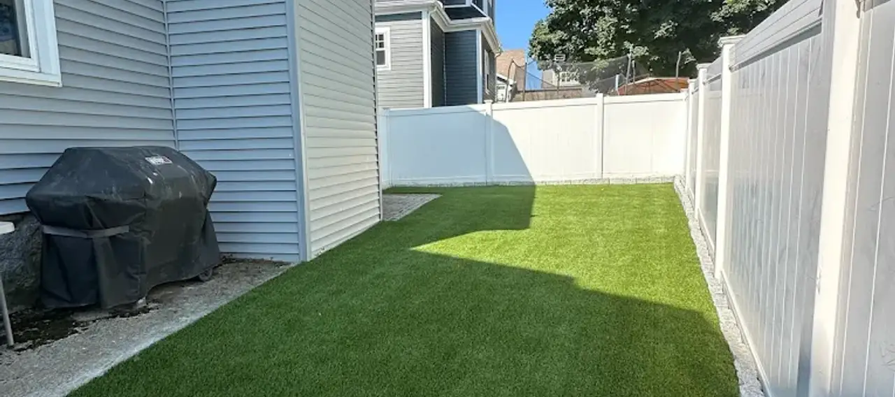 Artificial grass installation with clean edges on an Edmonton residential property.