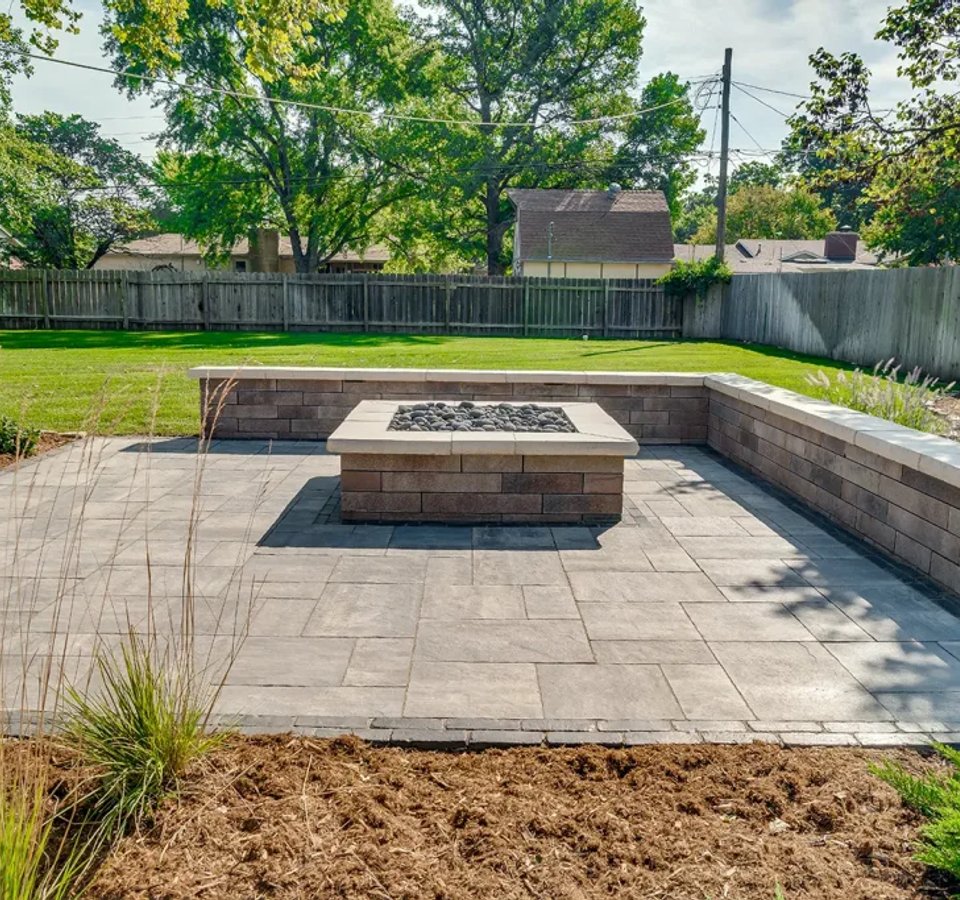 Backyard patio with firepit and retaining wall