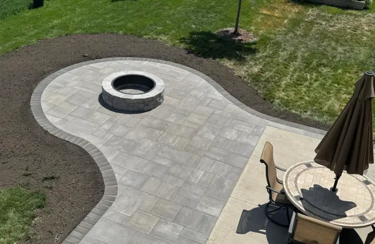 Custom paving stone patio with a fire pit installed by Serene Landscaping in Edmonton.