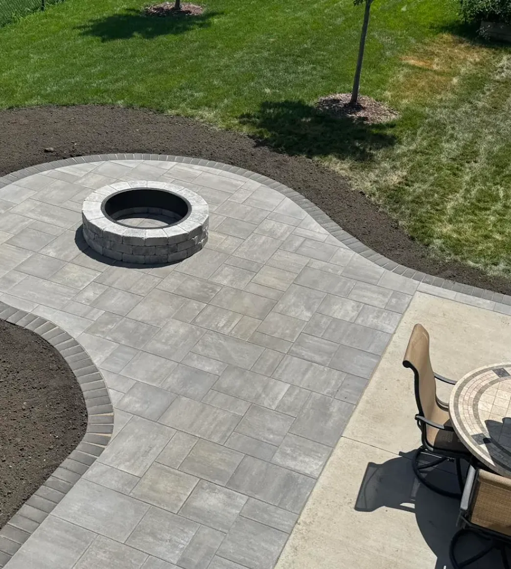 Custom paving stone patio with a fire pit installed by Serene Landscaping in Edmonton.