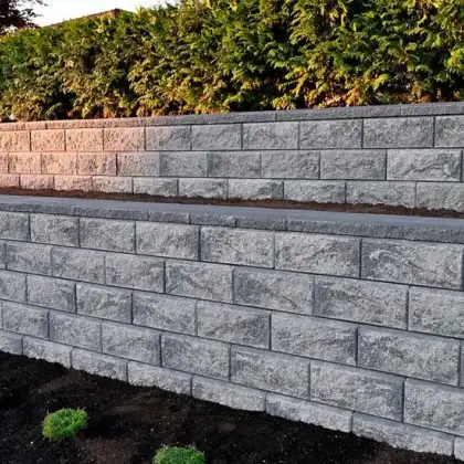 Tiered concrete block retaining wall installed for an Edmonton residential property.