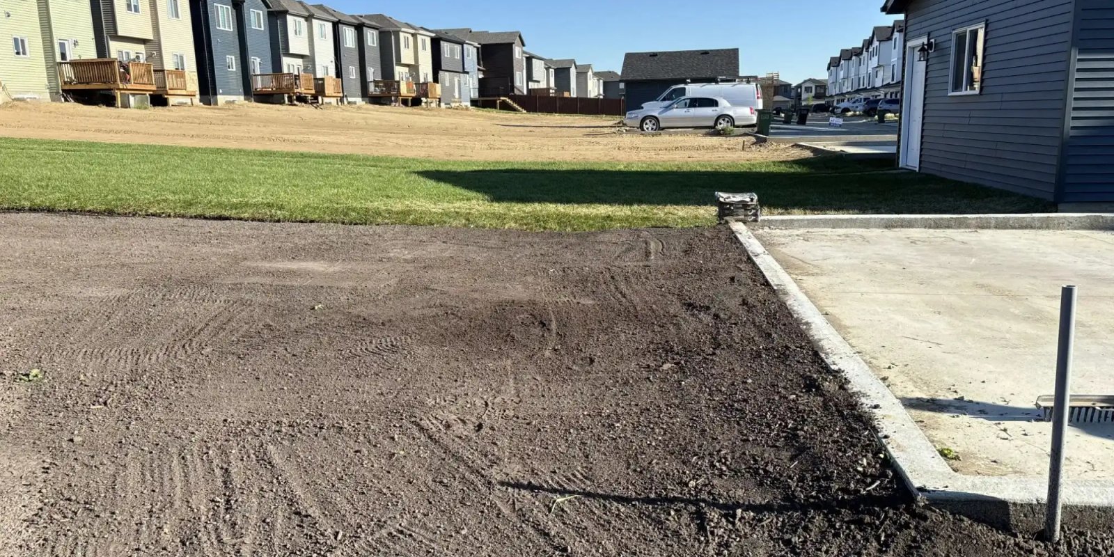 Final grading work on a new home property in Edmonton to complete builder landscaping requirements and recover the landscaping deposit.