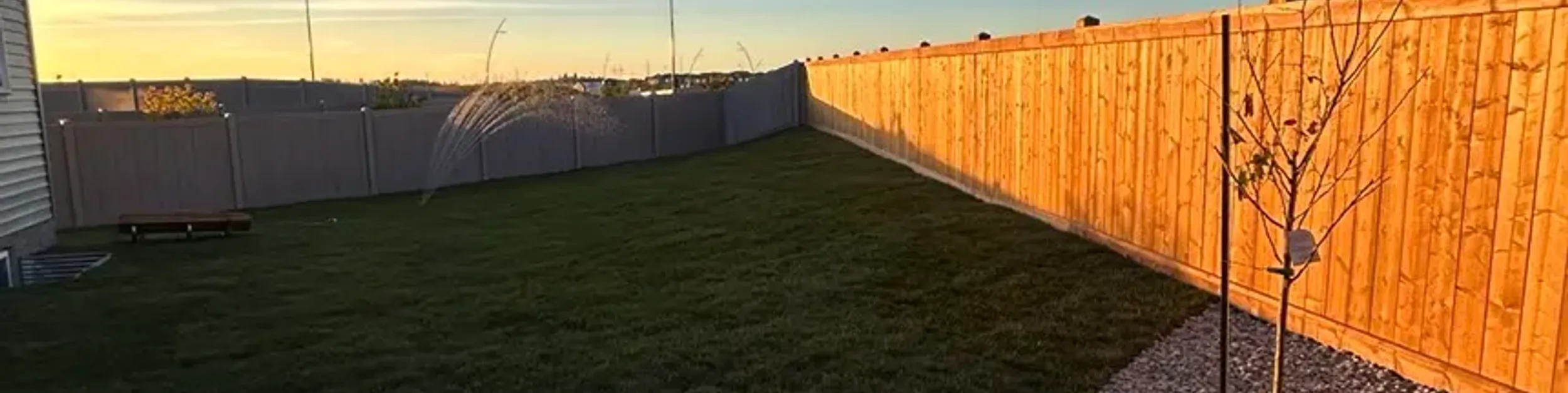 Completed landscape project with lawn and garden beds