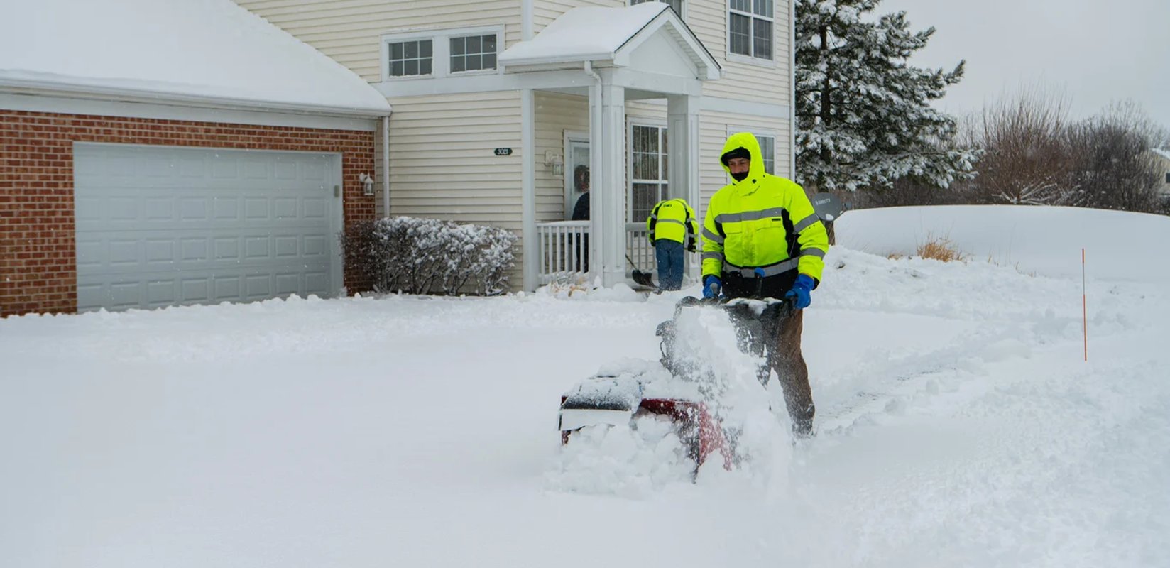 Serene Landscaping crew providing seasonal snow removal service at an Edmonton home